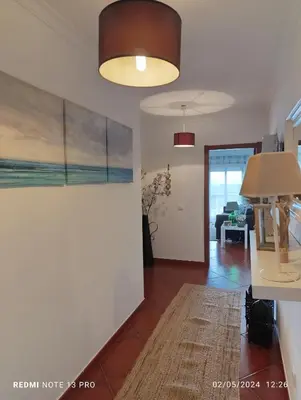 a living room with a painting on the wall at Balcony View Albufeira in Albufeira