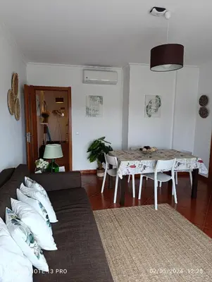 a living room with a couch and a table at Balcony View Albufeira in Albufeira