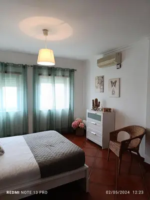 a bedroom with a bed and a table and chairs at Balcony View Albufeira in Albufeira