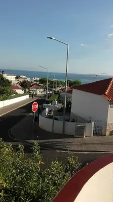 a stop sign on a street next to a building at Apartamento Sao Jose in Albufeira