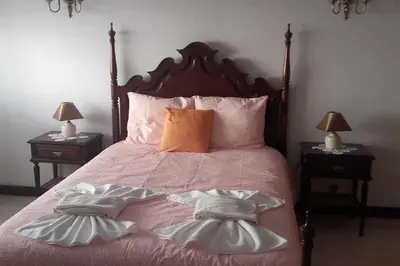 a bedroom with a bed with two nightstands and two lamps at Apartamento Sao Jose in Albufeira