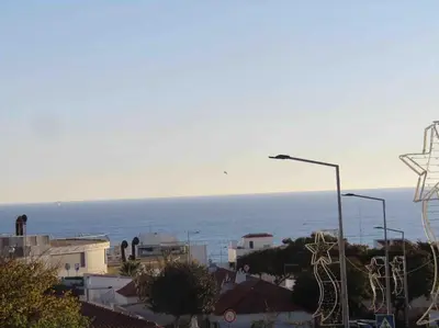 a street light with the ocean in the background at Apartamento Sao Jose in Albufeira