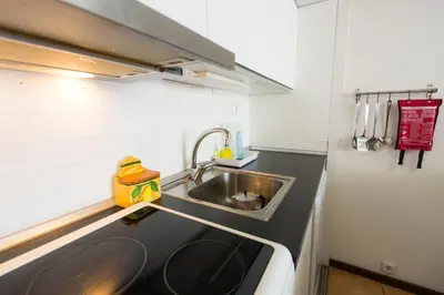 a small kitchen with a sink and a counter at Apartments near Marina de Vilamoura in Quarteira