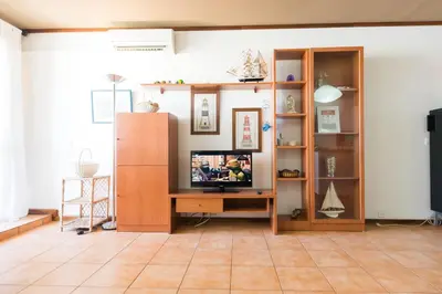 a living room with a television on a wooden table at Apartments near Marina de Vilamoura in Quarteira