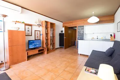 a living room with a couch and a kitchen at Apartments near Marina de Vilamoura in Quarteira