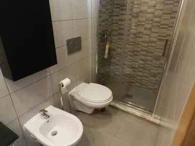 a bathroom with a toilet and a shower and a sink at Casa Da Baixa in Faro