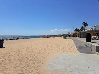 a sandy beach with people on it and the ocean at COLINA FÉRIAS- Garagem & WIFI in Quarteira