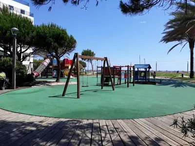 a park with a playground with a slide at COLINA FÉRIAS- Garagem & WIFI in Quarteira