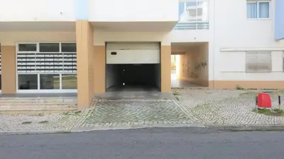 a building with a large door in the middle at COLINA FÉRIAS- Garagem & WIFI in Quarteira