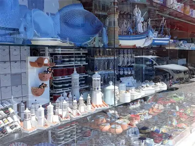 a display of ceramics in a store window at Dunas 3- Elegante, 150mt Praia, Wifi in Quarteira