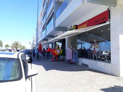 a store front of a building with people standing outside at Pontemira 5 Esplêndido in Quarteira