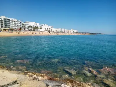 a view of a beach with buildings in the background at Torre Azul 11 Vista Panoramica in Quarteira