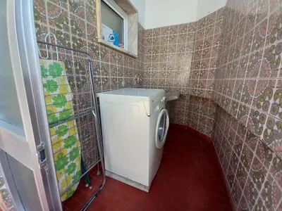 a small bathroom with a washing machine in it at Torre Azul 11 Vista Panoramica in Quarteira