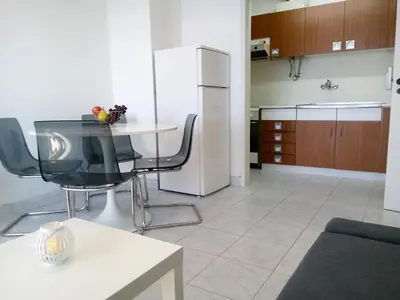 a kitchen with a table and chairs in a room at TORRE 14 Vista Magnifica in Quarteira