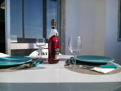 a bottle of wine sitting on a table with glasses at TORRE 14 Vista Magnifica in Quarteira
