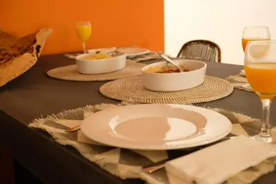a table with plates of food and glasses of orange juice at Yellow House - Checkinhome in Boliqueime