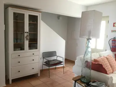 a living room with a white couch and a dresser at Yellow House - Checkinhome in Boliqueime
