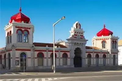 a building with two red roofs and a street light at cosy2bedroomapartment in Loulé