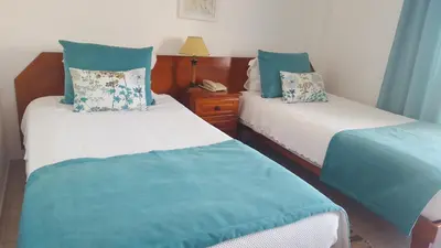 two beds in a room with blue and white at Mira Parque in Albufeira