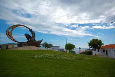 a statue of a person sitting on a boat at Vila Baltum - Free private parking - Wifi - Airco # by bedzy # in Albufeira