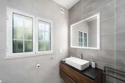 a bathroom with a sink and a mirror at Exclusive Villa Toulouse with pool in Falesia Algarve in Albufeira