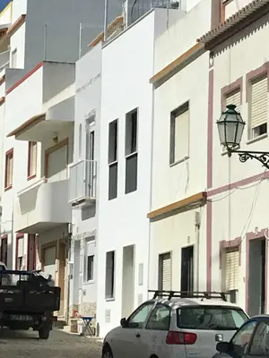 a car parked in front of a white building at Casa Indigo- Perfect location & Sea View by DreamvillasAlbufeira in Albufeira