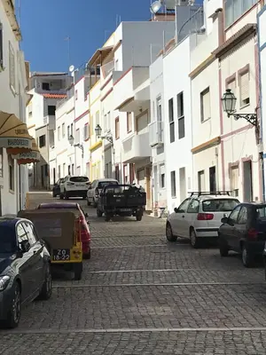 a group of cars parked on a street with buildings at Casa Indigo- Perfect location & Sea View by DreamvillasAlbufeira in Albufeira