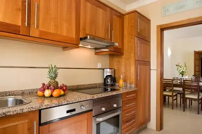 a kitchen with a sink and a counter with fruit on it at Silmar in Albufeira