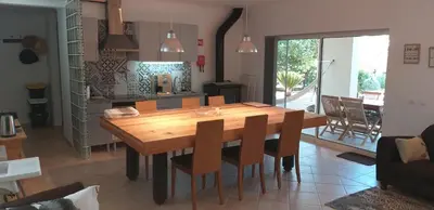 a kitchen and dining room with a wooden table and chairs at FIND Your Space Casa no Campo - Paderne - Albufeira - Piscina Privada - Aquecida a pedido in Paderne