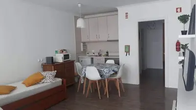 a kitchen and a table and chairs in a room at Hello Chloé in Vilamoura