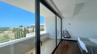 a bedroom with glass doors and a bed and a window at Passion by Check-in Portugal in Albufeira