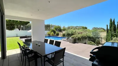 a patio with a table and chairs and a swimming pool at Passion by Check-in Portugal in Albufeira