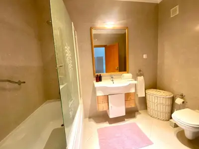 a bathroom with a sink and a toilet and a shower at Apartamento Vista Golfe Mar Vilamoura in Vilamoura