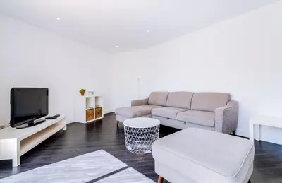 a living room with a couch and a tv at AL - Apartamento Terracos da Falesia in Vilamoura