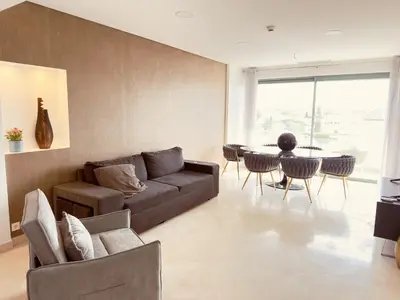 a dining room with a table and chairs and a large window at VilamouraSun Aquamar 518 - Fantástico Vista in Vilamoura