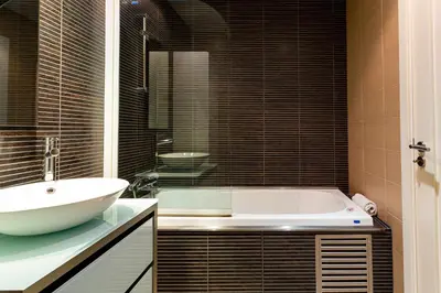 a bathroom with a white tub and a sink at VilamouraSun Aquamar 518 - Fantástico Vista in Vilamoura
