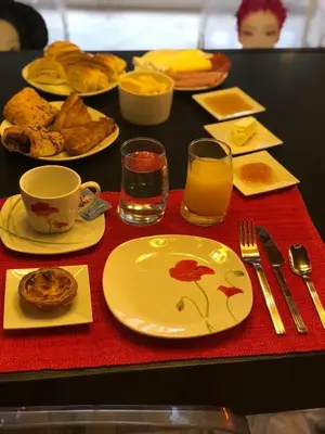 a table with plates of food and glasses of orange juice at Villa Monaco in Faro