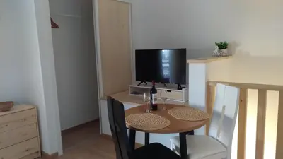 a small dining room with a table and a television at Apt Cardoso 3 ao lado da Praia Peneco in Albufeira