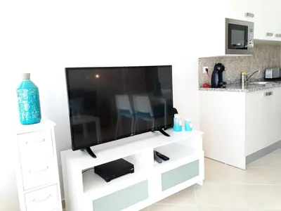 a flat screen tv on a white entertainment center at T1 PraiaMar RC com Ar-Condicionado in Quarteira