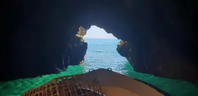 a boat in a cave in the ocean at Apartamento T2 Encosta sao jose in Albufeira