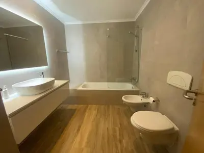 a bathroom with a sink and a toilet and a tub at Corcovada 37 in Albufeira