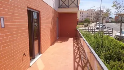 a balcony of a building with a brick wall at Corcovada 37 in Albufeira