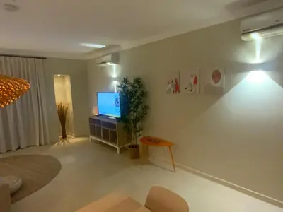 a living room with a flat screen tv on a wall at Corcovada 37 in Albufeira