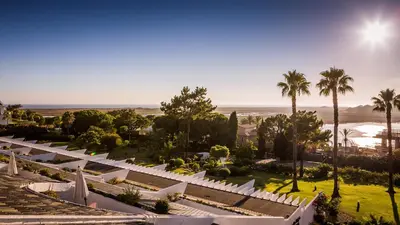 an aerial view of a resort with palm trees and the beach at Quinta do Lago Country Club in Quinta do Lago