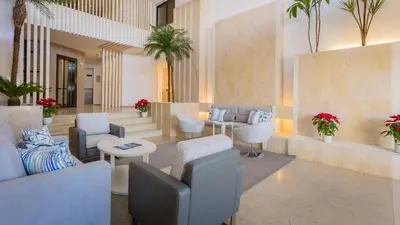 a lobby with couches and chairs and a table at Quinta do Lago Country Club in Quinta do Lago