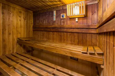 an empty wooden sauna with a bench in it at Quinta do Lago Country Club in Quinta do Lago