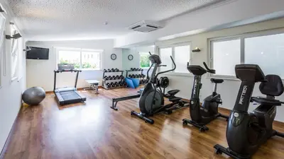 a gym with treadmills and exercise bikes in a room at Quinta do Lago Country Club in Quinta do Lago