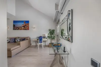 a living room with a couch and a table at Renovated Vilamoura Penthouse Near Marina & Beach in Vilamoura