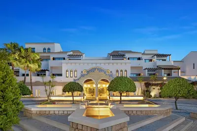 a hotel with a fountain in front of a building at Pine Cliffs Hotel, a Luxury Collection Resort, Algarve in Albufeira