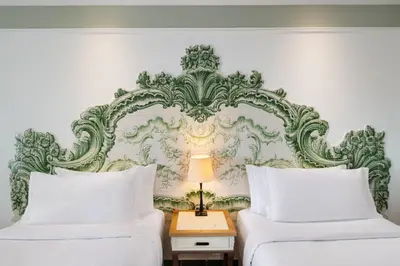 a bedroom with two beds and a headboard at Pine Cliffs Hotel, a Luxury Collection Resort, Algarve in Albufeira
